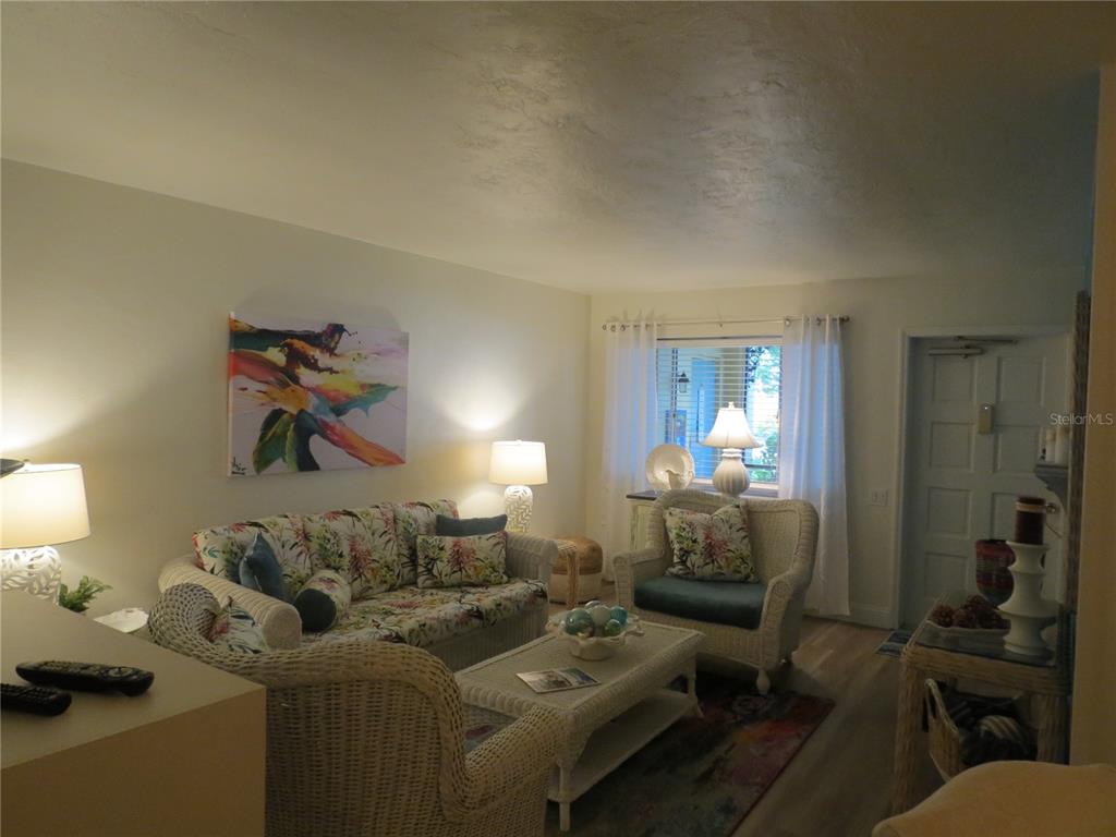 615 South Palm Avenue, Unit 4 Sarasota, FL 34236 - Photo 8 of 16 a living room with furniture and a chandelier