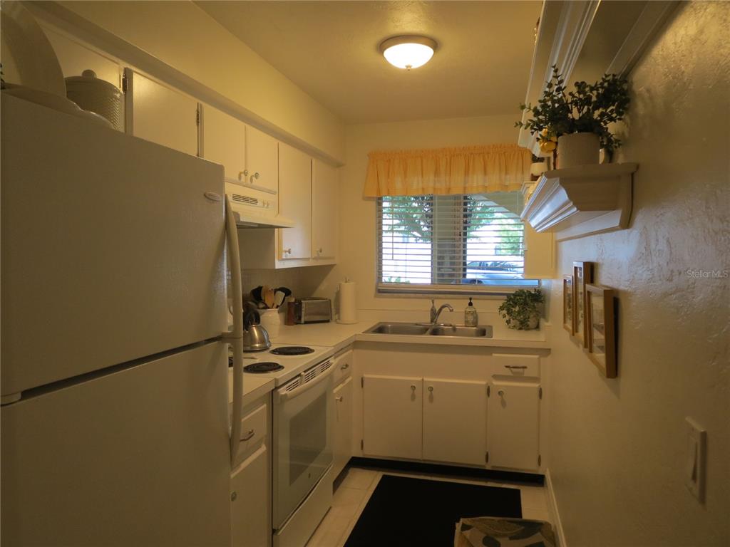 615 South Palm Avenue, Unit 4 Sarasota, FL 34236 - Photo 9 of 16 a room with sink a washer and dryer