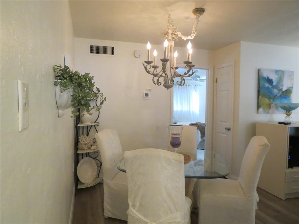 615 South Palm Avenue, Unit 4 Sarasota, FL 34236 - Photo 10 of 16 a dining room with furniture and a chandelier