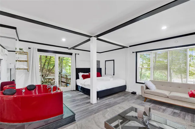 a living room with furniture and large windows