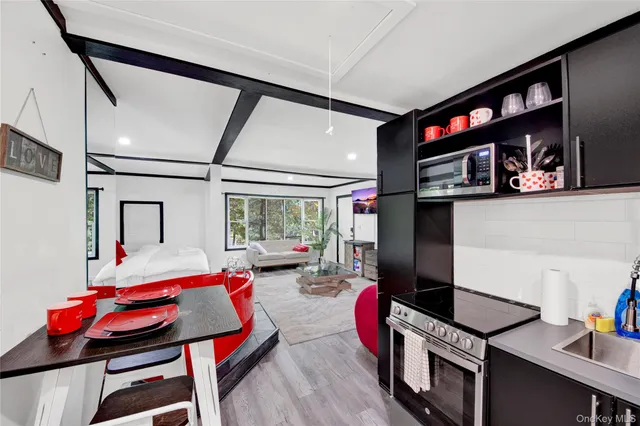 a living room with furniture a rug and a flat screen tv