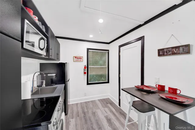a view of a hallway with furniture and wooden floor