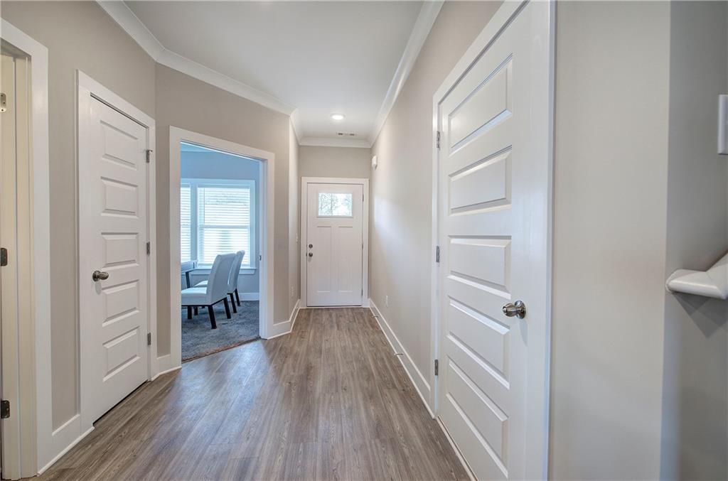200 Daisy Court Cartersville, GA 30121 - Photo 33 of 73 a view of a hallway with wooden floor and a bathroom