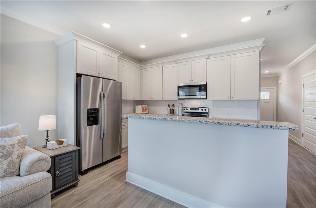 200 Daisy Court Cartersville, GA 30121 - Photo 36 of 73 a kitchen with stainless steel appliances a refrigerator and a stove top oven
