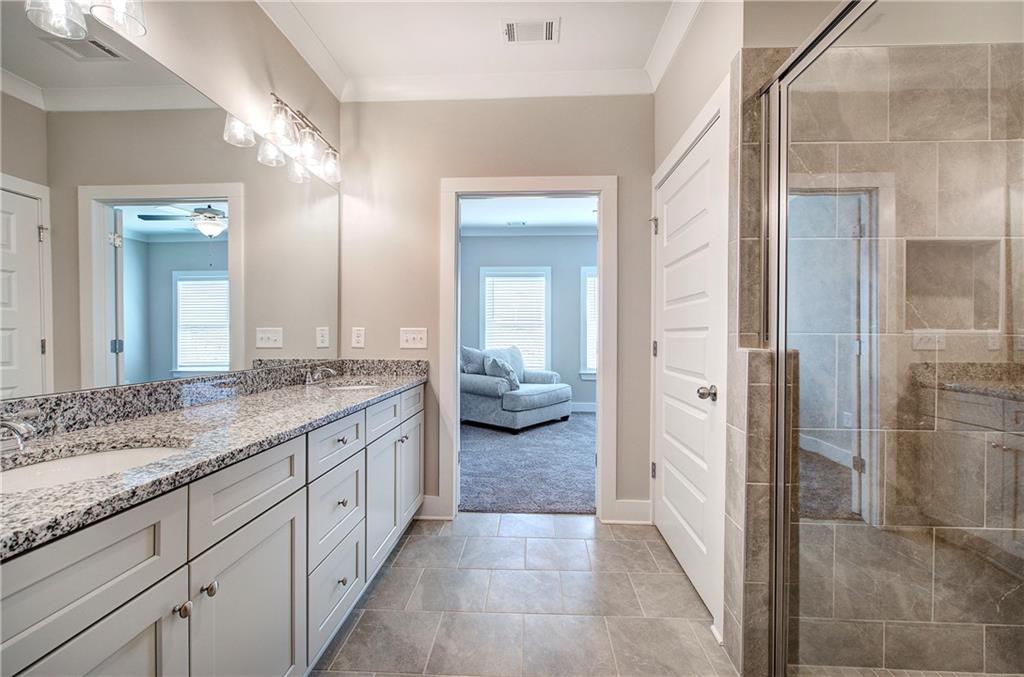 200 Daisy Court Cartersville, GA 30121 - Photo 39 of 73 a en suite bathroom with a granite countertop sink mirror and toilet