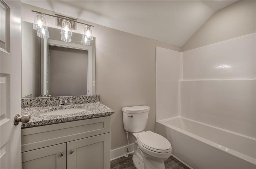 200 Daisy Court Cartersville, GA 30121 - Photo 52 of 73 a bathroom with a granite countertop sink toilet and shower