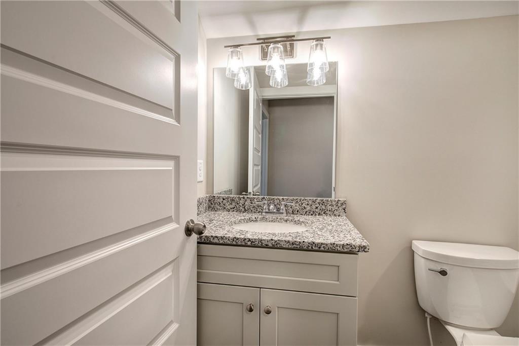 200 Daisy Court Cartersville, GA 30121 - Photo 56 of 73 a bathroom with a granite countertop sink a toilet and a mirror