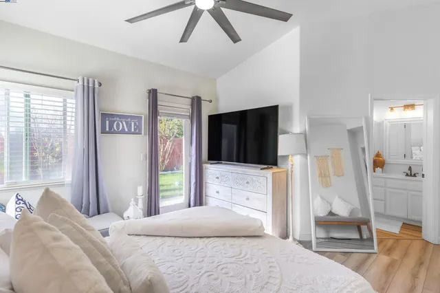 a bedroom with a bed and a television