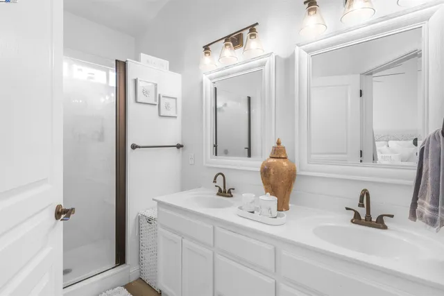 a bathroom with double sink and a mirror
