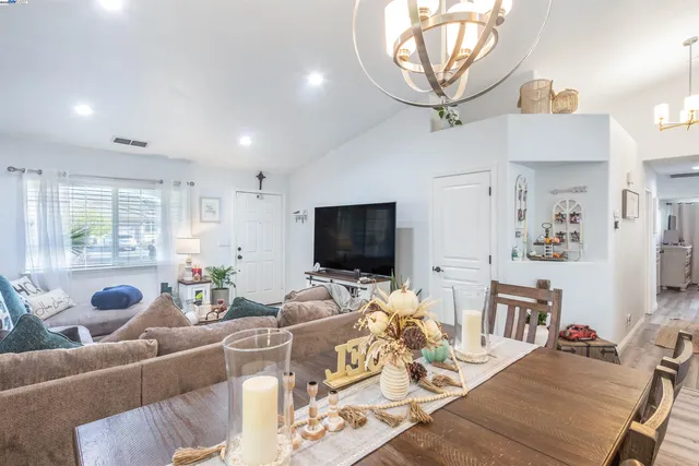 a living room with furniture a flat screen tv and a window