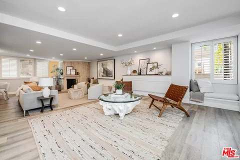a large white kitchen with stainless steel appliances granite countertop lots of counter top space and cabinets