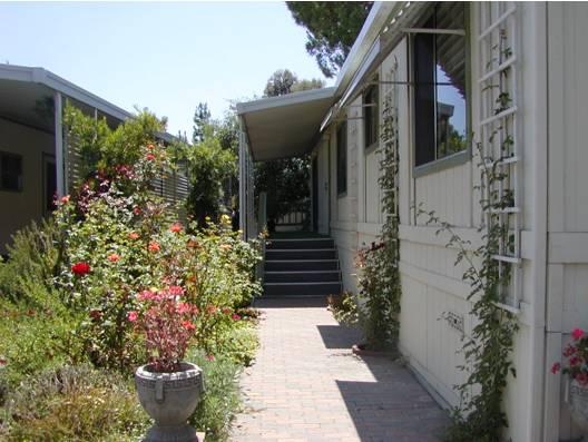 1273 South Rice Road Ojai, CA 93023 - Photo 1 of 5 a house with flower garden and wooden fence