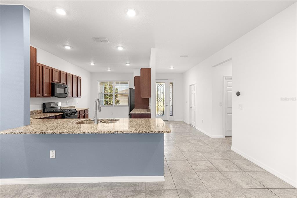 8546 Southwest 79th Avenue Ocala, FL 34476 - Photo 12 of 42 a large kitchen with granite countertop a large counter top stainless steel appliances and cabinets