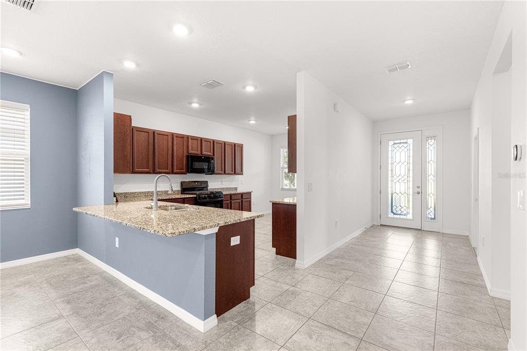 8546 Southwest 79th Avenue Ocala, FL 34476 - Photo 13 of 42 a large kitchen with stainless steel appliances granite countertop a large counter top and a stove top oven
