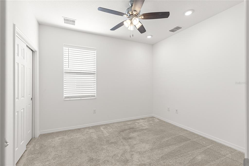 8546 Southwest 79th Avenue Ocala, FL 34476 - Photo 20 of 42 an empty room with a window and a fan