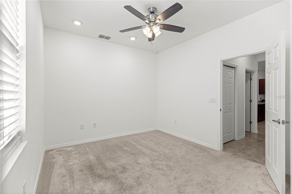8546 Southwest 79th Avenue Ocala, FL 34476 - Photo 22 of 42 an empty room with a window and a ceiling fan