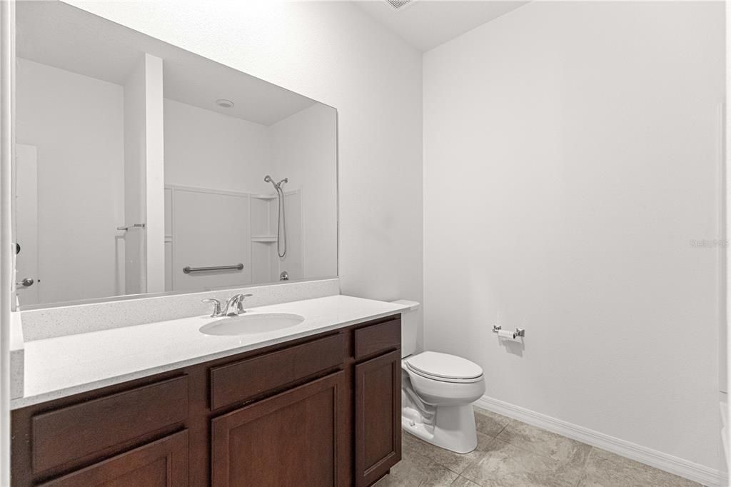 8546 Southwest 79th Avenue Ocala, FL 34476 - Photo 23 of 42 a bathroom with a toilet a sink and a mirror