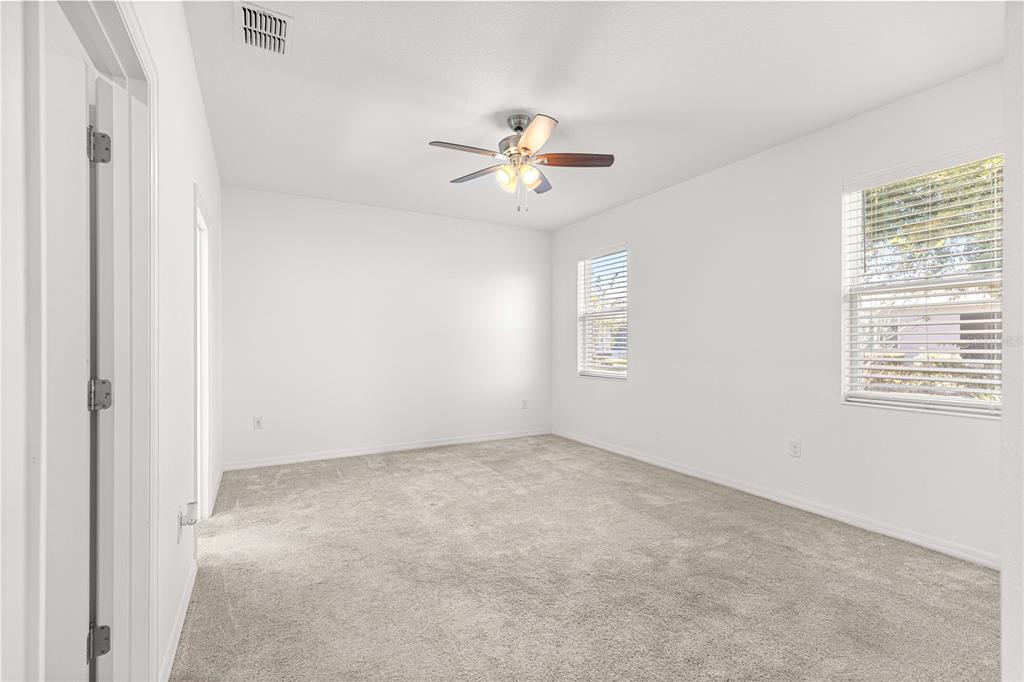 8546 Southwest 79th Avenue Ocala, FL 34476 - Photo 27 of 42 an empty room with windows and fan