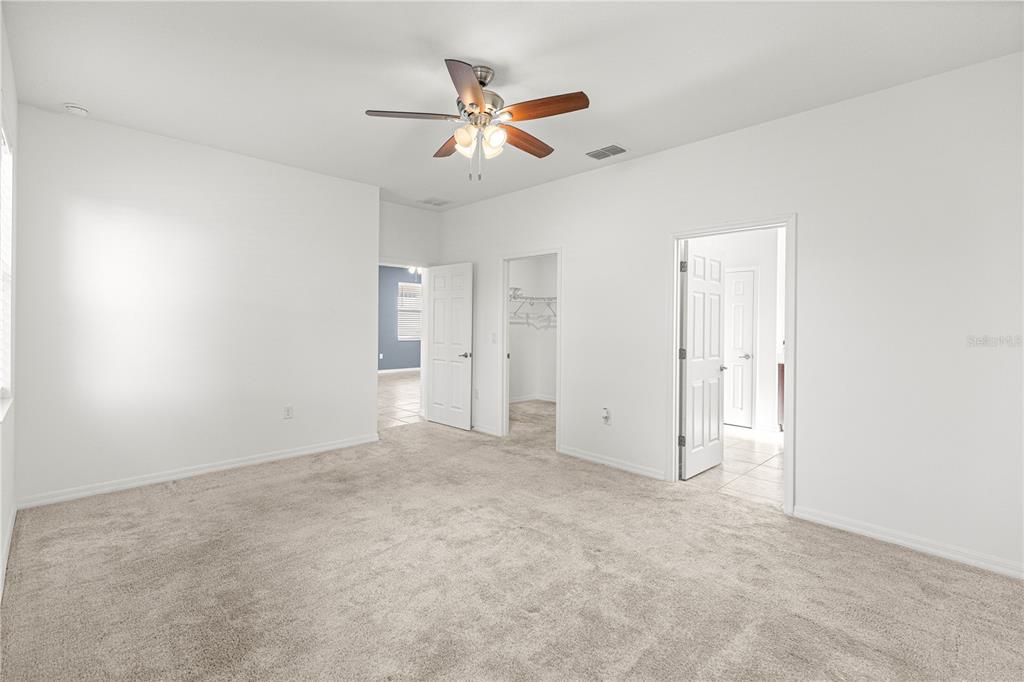8546 Southwest 79th Avenue Ocala, FL 34476 - Photo 28 of 42 an empty room with closet and ceiling fan