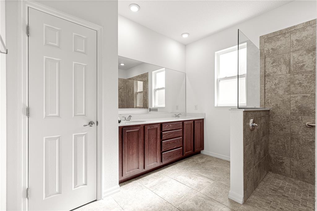 8546 Southwest 79th Avenue Ocala, FL 34476 - Photo 31 of 42 a bathroom with a granite countertop sink mirror and