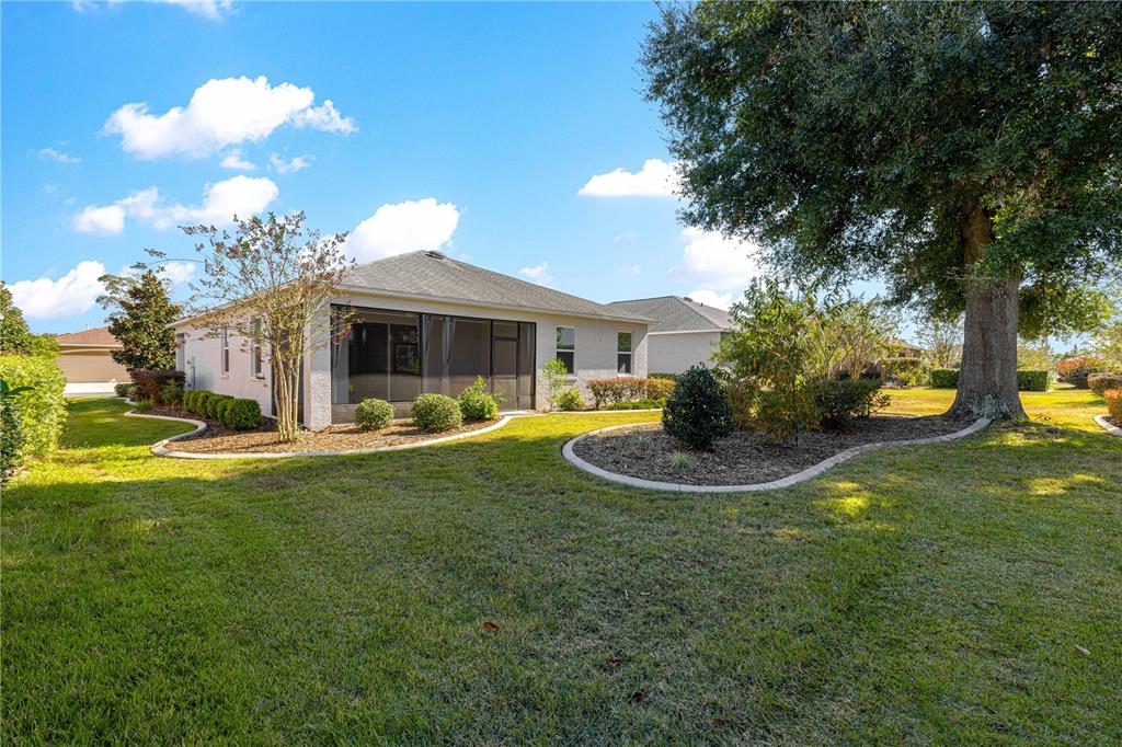 8546 Southwest 79th Avenue Ocala, FL 34476 - Photo 40 of 42 a view of a house with swimming pool and a garden