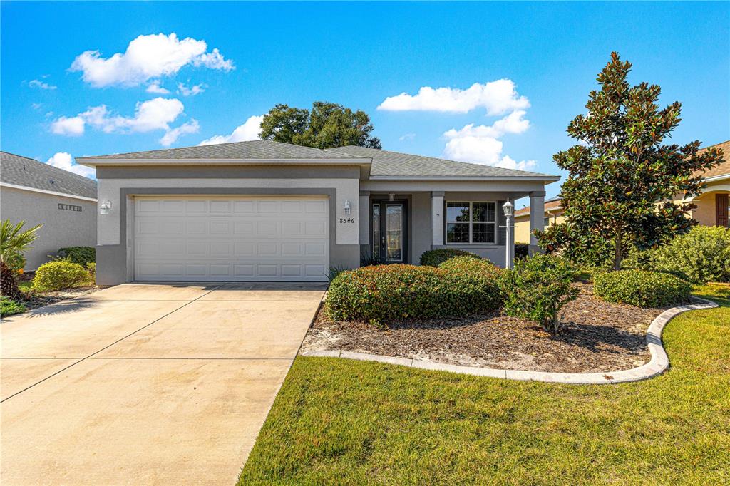 8546 Southwest 79th Avenue Ocala, FL 34476 - Photo 42 of 42 a view of a white house with a yard and potted plants