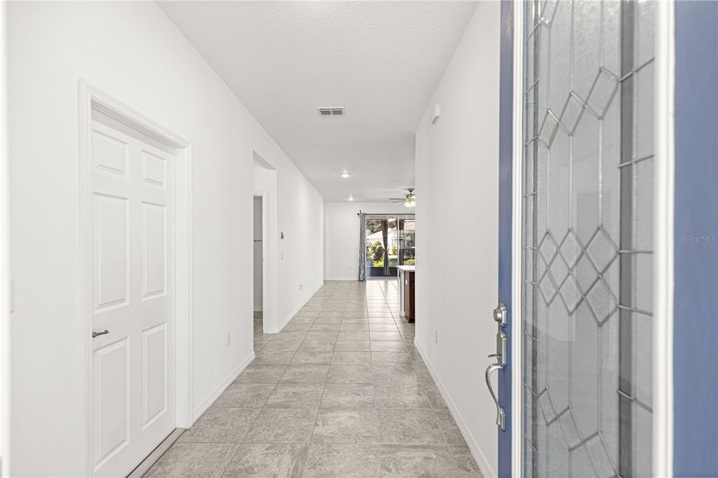 8546 Southwest 79th Avenue Ocala, FL 34476 - Photo 6 of 42 a view of a hallway with wooden floor and staircase