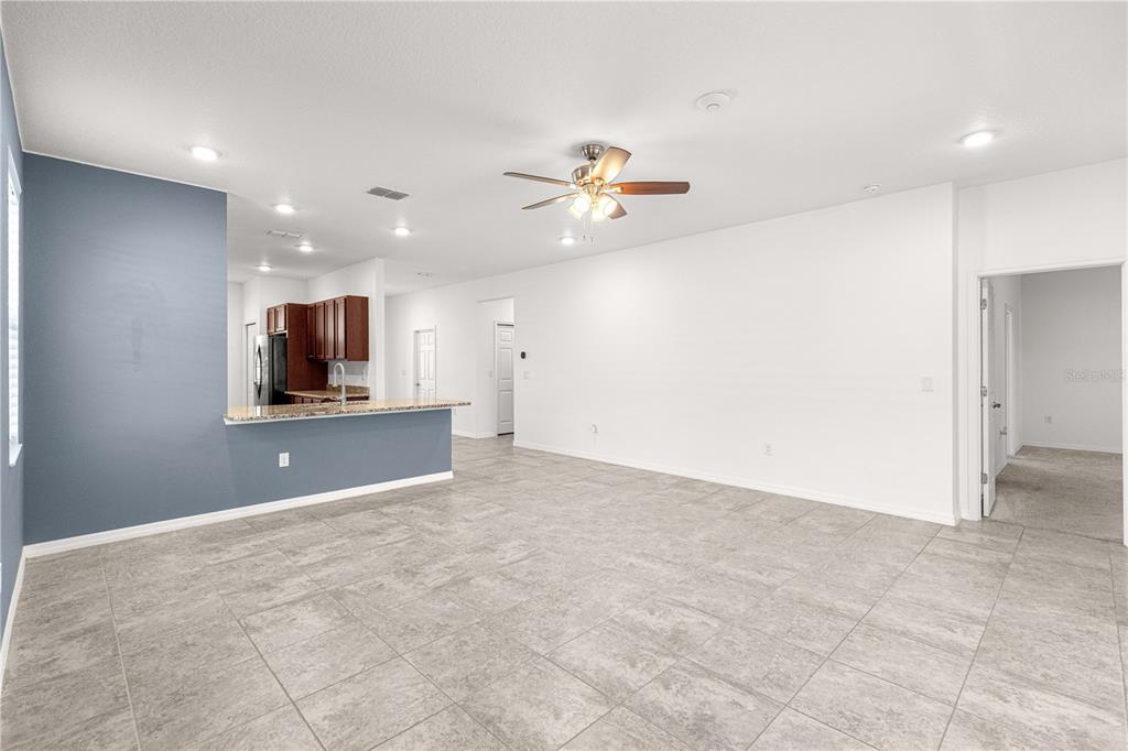 8546 Southwest 79th Avenue Ocala, FL 34476 - Photo 9 of 42 a view of an empty room with a ceiling fan
