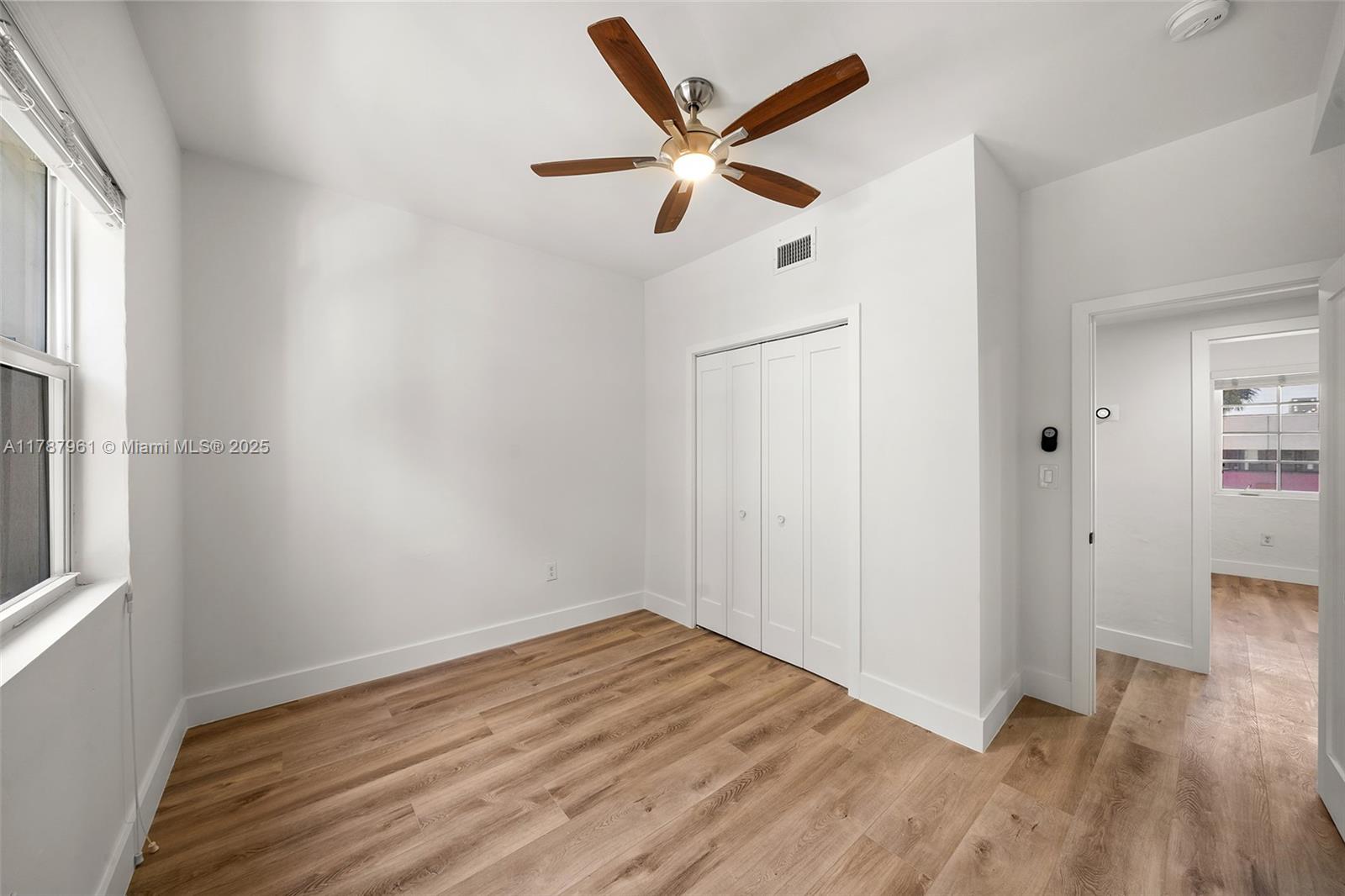 2411 Biscayne Boulevard, Unit 2 Miami, FL 33137 - Photo 11 of 25 wooden floor in an empty room with a window