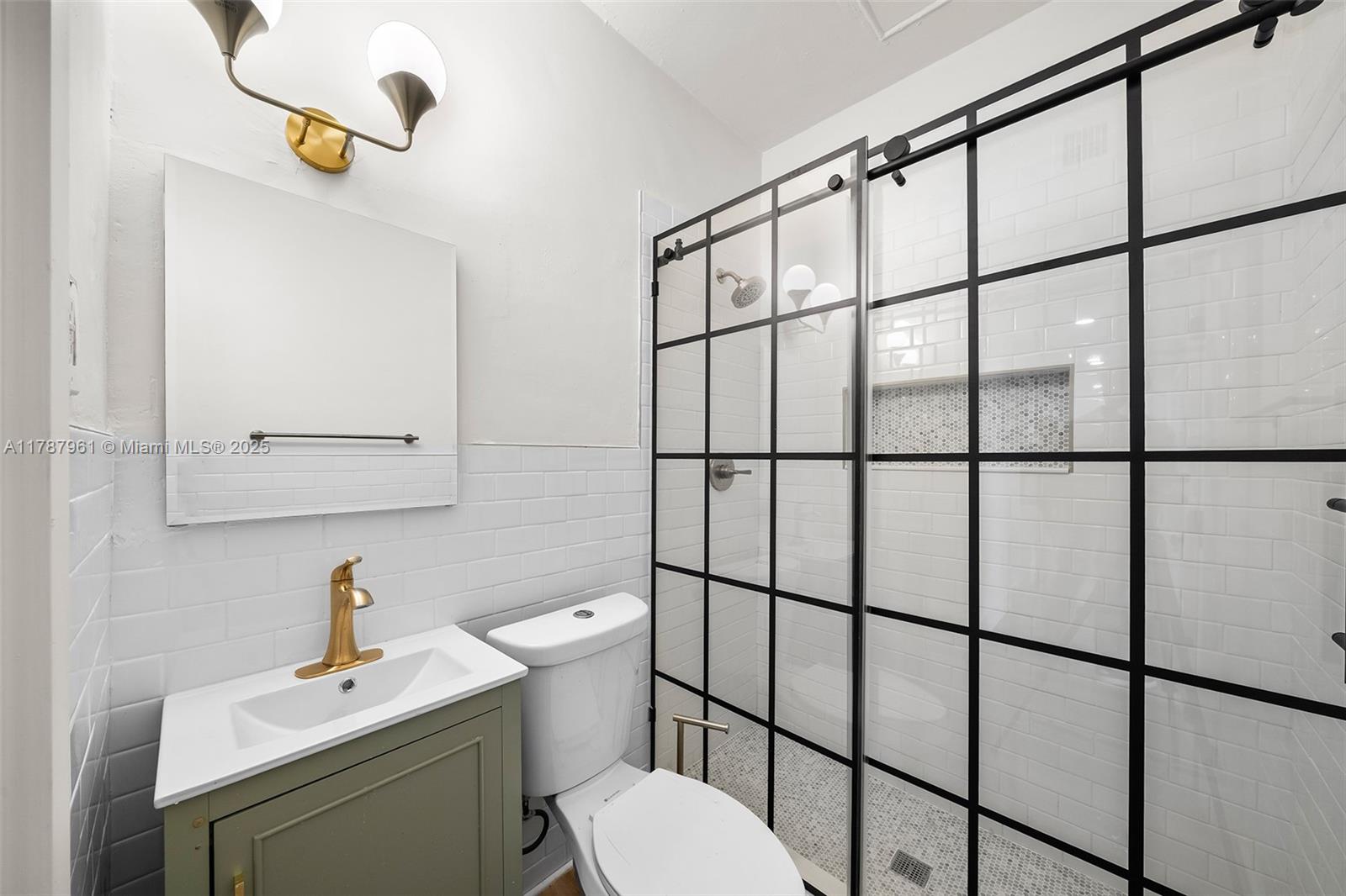 2411 Biscayne Boulevard, Unit 2 Miami, FL 33137 - Photo 14 of 25 a bathroom with a sink toilet and mirror