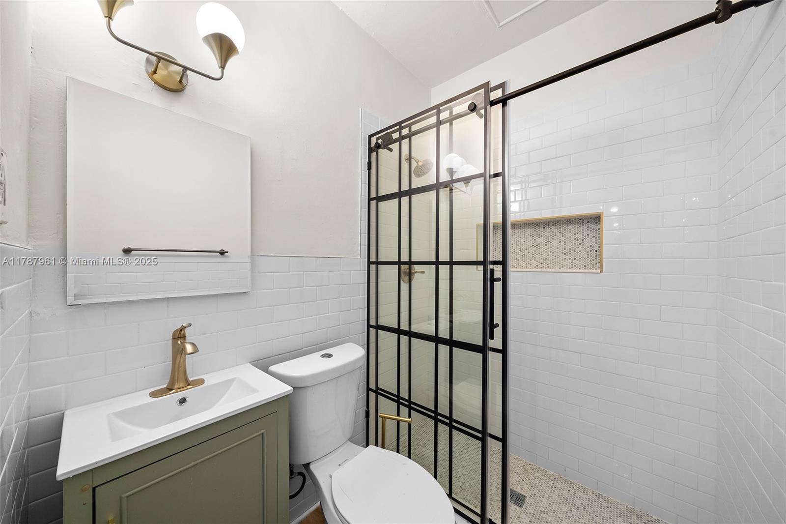 2411 Biscayne Boulevard, Unit 2 Miami, FL 33137 - Photo 15 of 25 a bathroom with a sink a toilet and shower