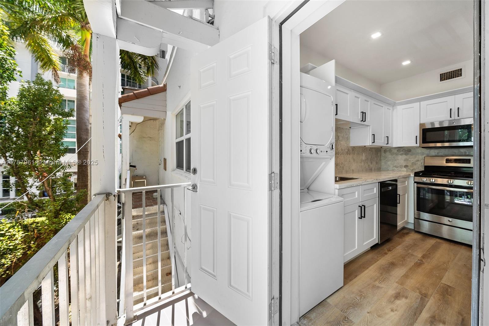 2411 Biscayne Boulevard, Unit 2 Miami, FL 33137 - Photo 23 of 25 a kitchen with stainless steel appliances a refrigerator and a stove top oven