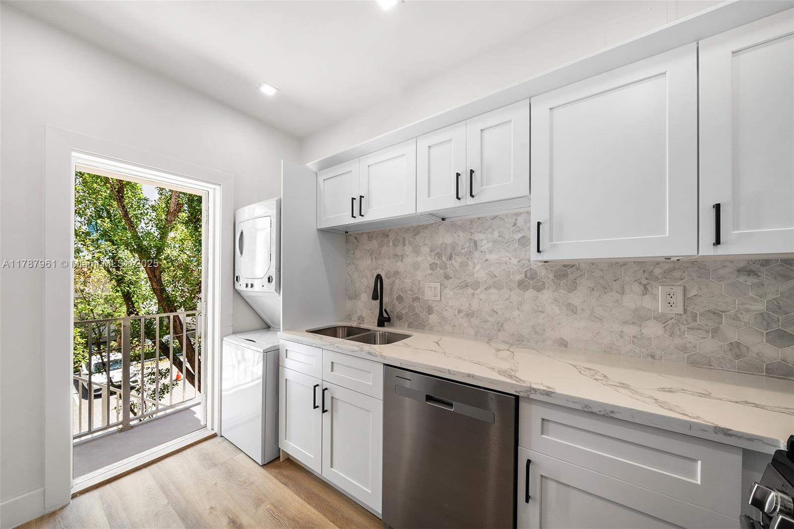 2411 Biscayne Boulevard, Unit 2 Miami, FL 33137 - Photo 5 of 25 a kitchen with a sink stove and cabinets