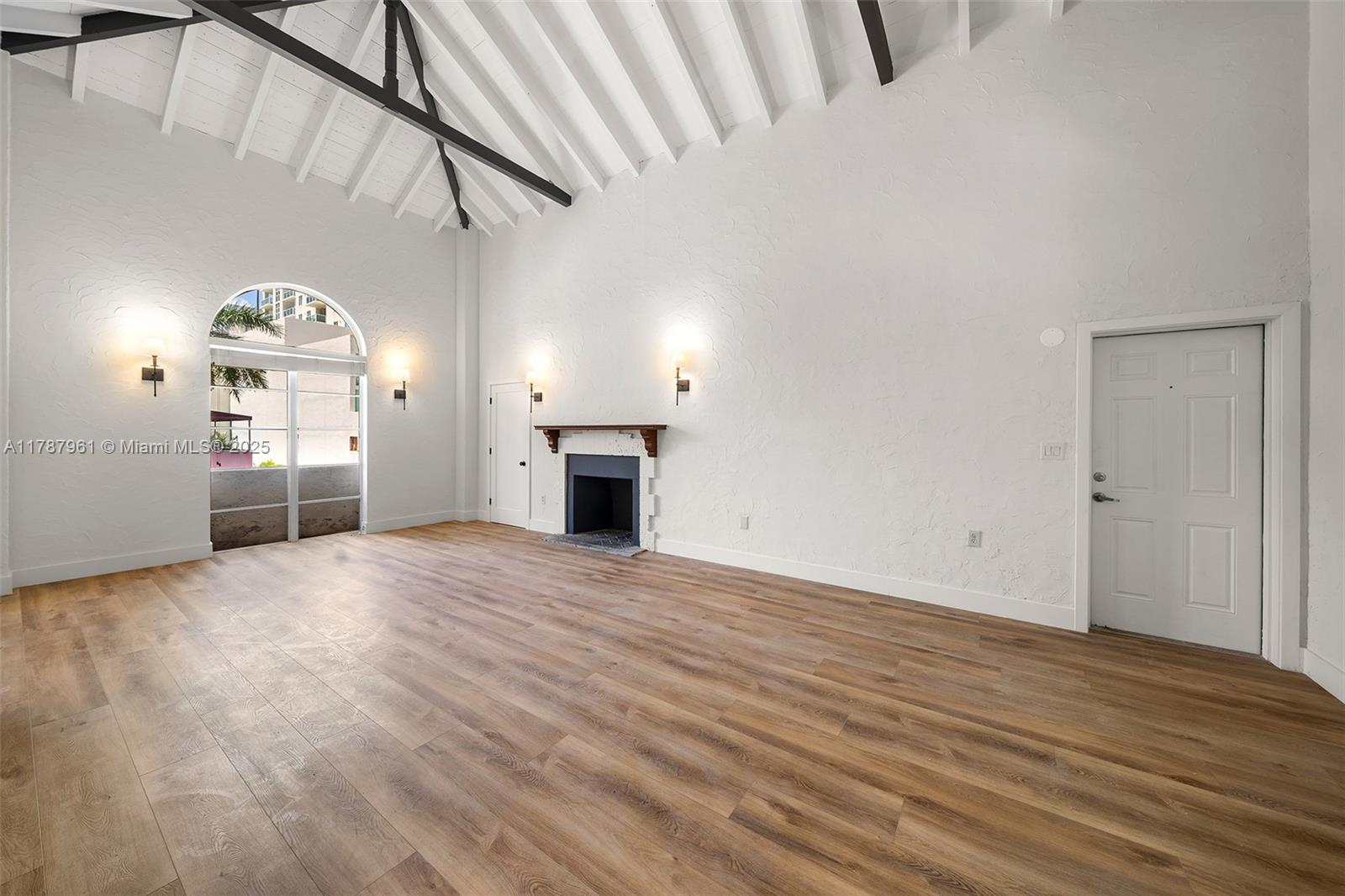 2411 Biscayne Boulevard, Unit 2 Miami, FL 33137 - Photo 9 of 25 a view of empty room with wooden floor