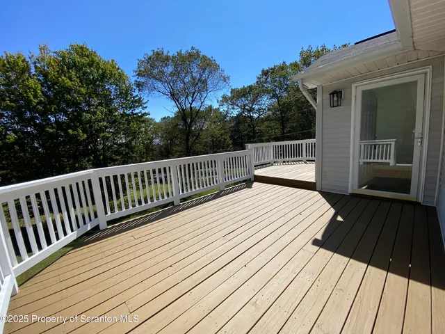 a view of deck with wooden floor and fence