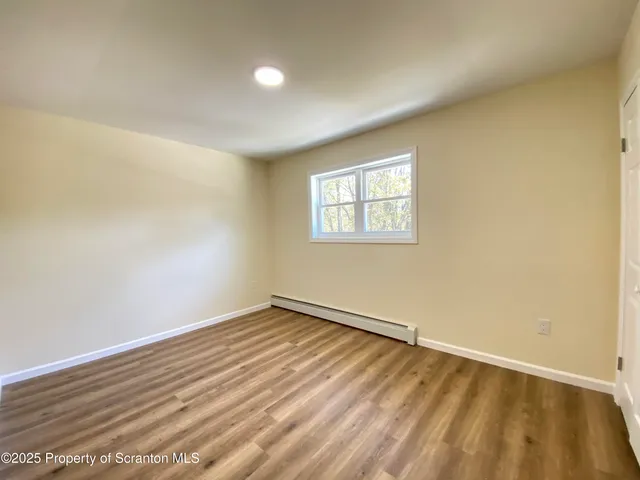 a view of room with window and hardwood floor