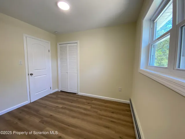 a spacious bathroom with a double vanity sink toilet mirror and shower