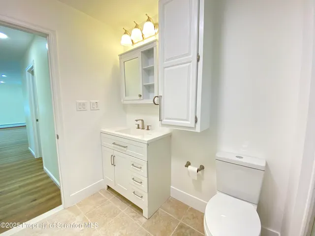 a view of a backyard with table and chairs under an umbrella