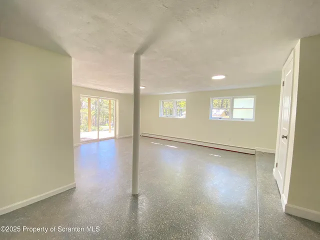 a view of a room with wooden floor and white wall