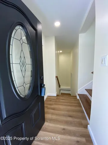 a view of a entryway with wooden floor