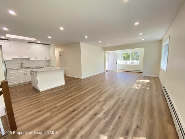 a view of kitchen with wooden floor and electronic appliances