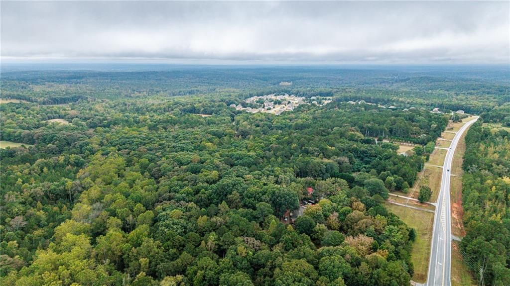 0 Ga-81 Covington, GA 30014 - Photo 10 of 17 an aerial view of a city with lots of residential buildings and mountain view in back