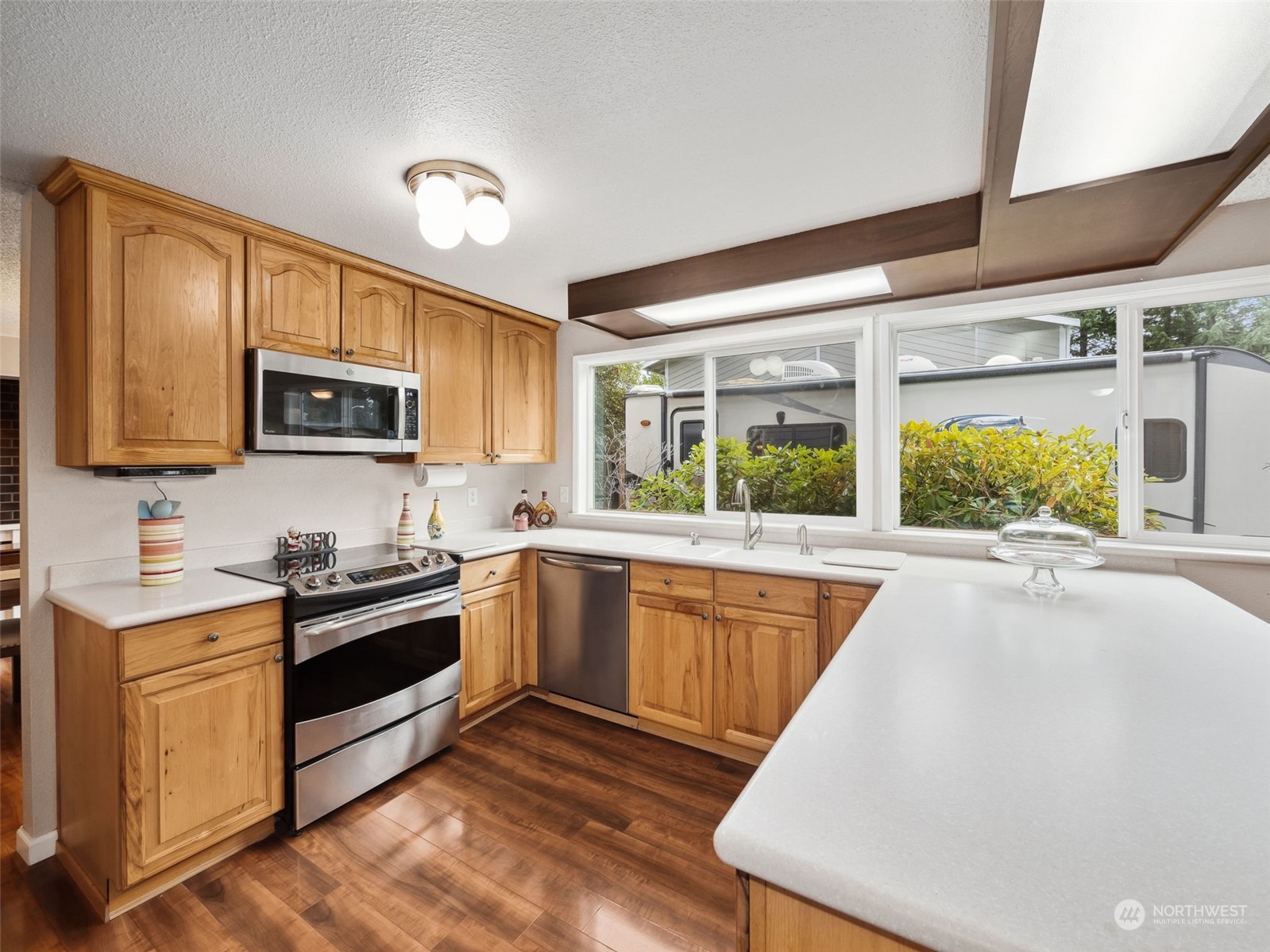 14130 148th Place Southeast Renton, WA 98059 - Photo 6 of 39 a kitchen with wooden cabinets stove top oven and sink