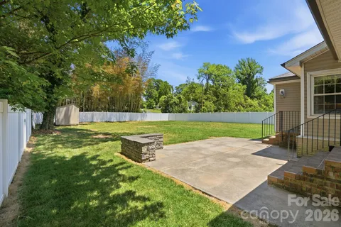 a view of a backyard with a garden and entertaining space