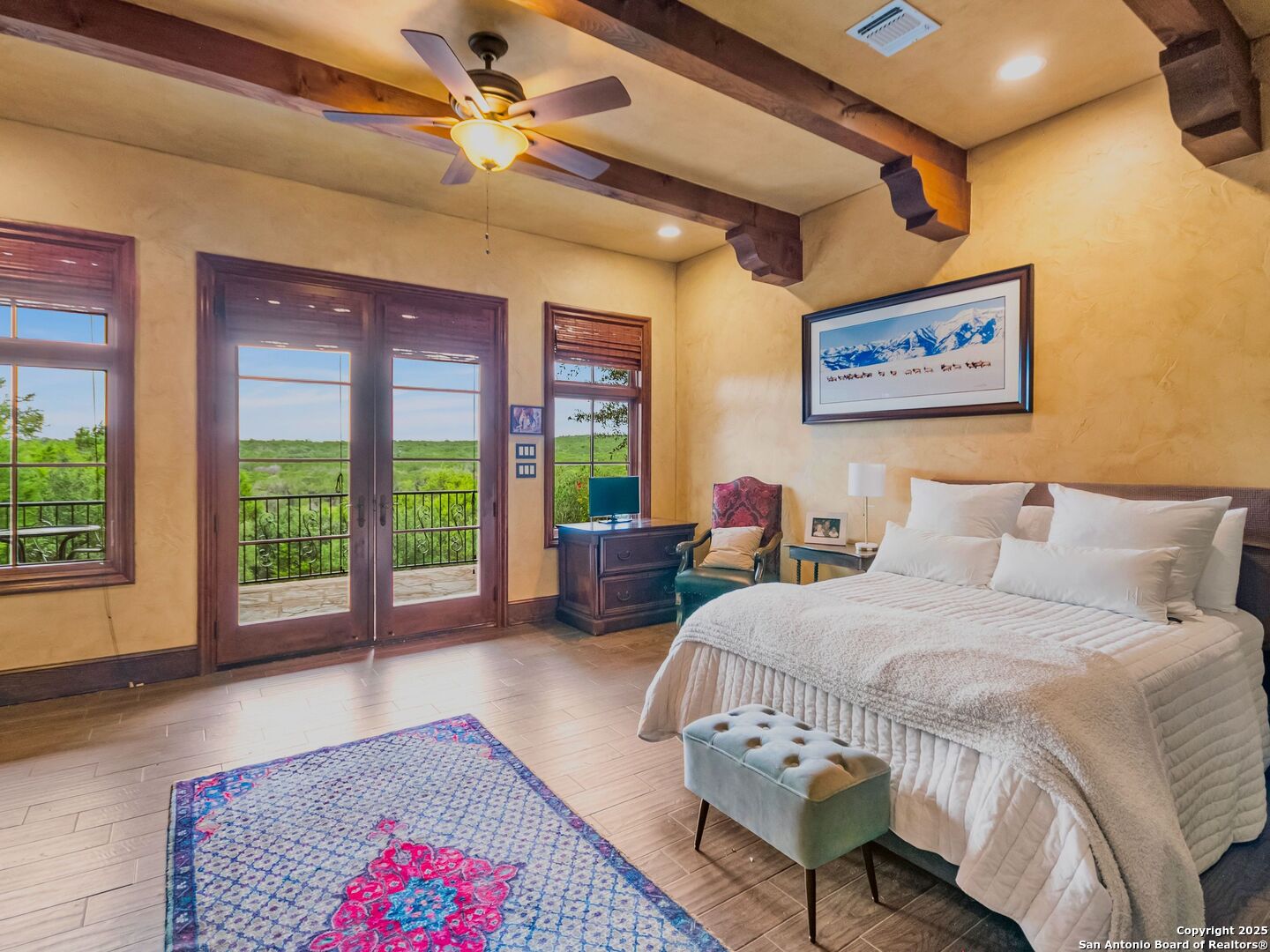 103 Castle Rock Boerne, TX 78006 - Photo 65 of 99 a spacious bedroom with a balcony a bed and a couch