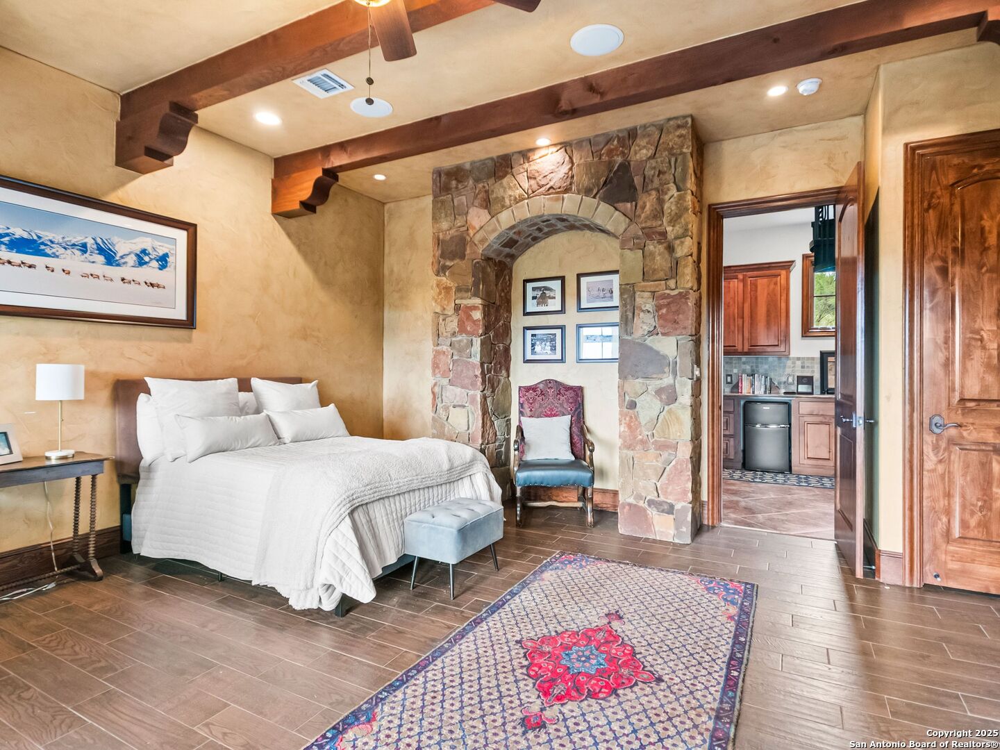 103 Castle Rock Boerne, TX 78006 - Photo 66 of 99 a spacious bedroom with a bed a mirror and desk