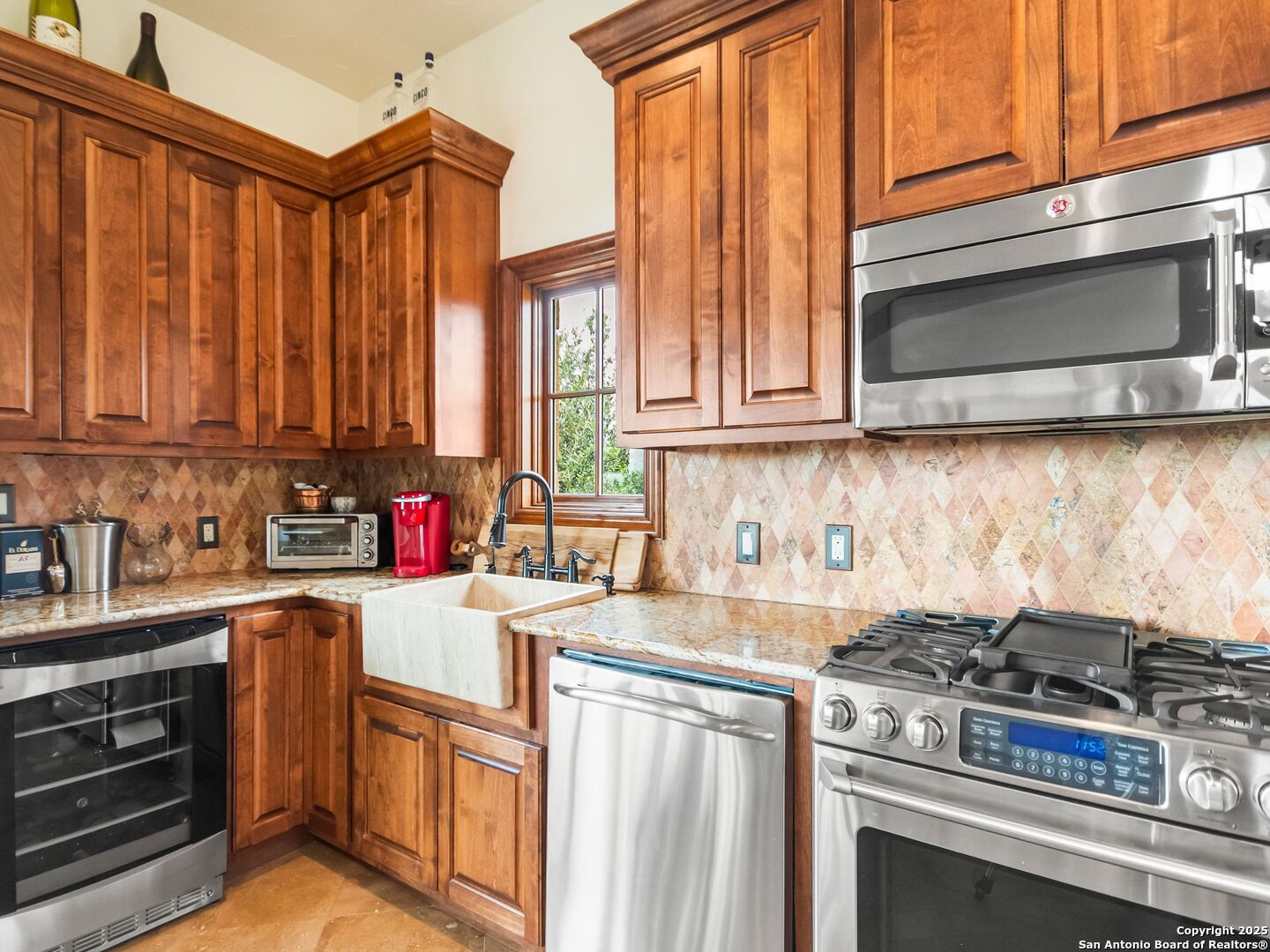 103 Castle Rock Boerne, TX 78006 - Photo 75 of 99 a kitchen with stainless steel appliances granite countertop a stove a sink and a microwave