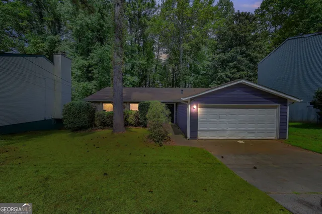 a view of a house with a yard and garage