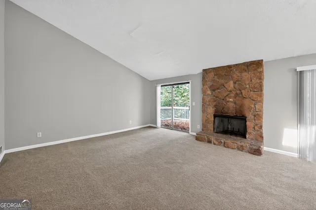 an empty room with a fireplace