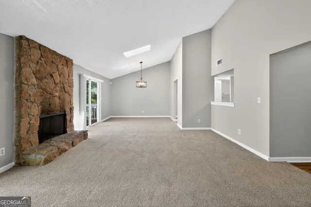 a view of an empty room with a fireplace